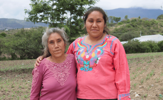 Artesanas de tejido de palma en Río Mijangos, Oaxaca Dos mujeres artesanas de Río Mijangos sonriendo al aire libre en la Sierra Sur de Oaxaca